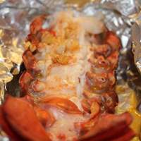 Wrap our lobster tails loosely in foil after adding garlic butter & grill or bake for 12 mins small or 22 mins large.